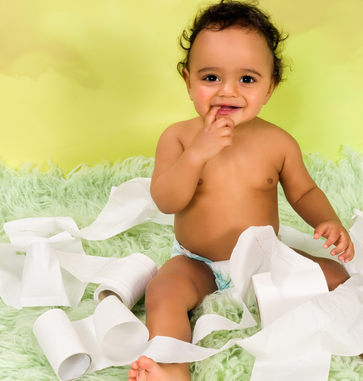 baby surrounded by toilet paper rolls